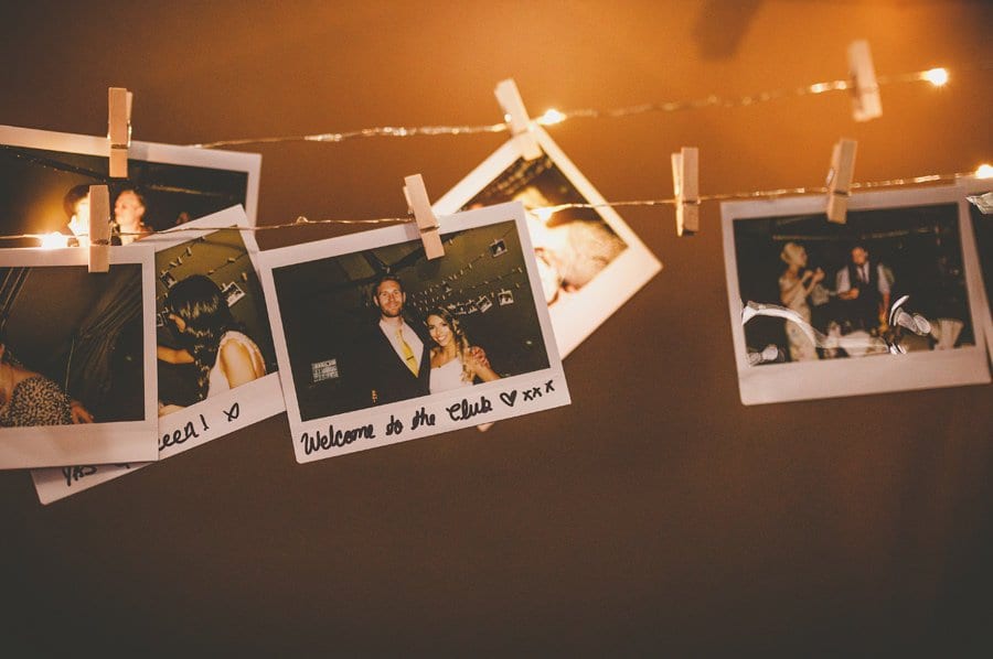 Polaroid photographs hang on string in the tipi
