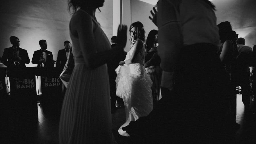 The bride dances on the dancefloor with friends