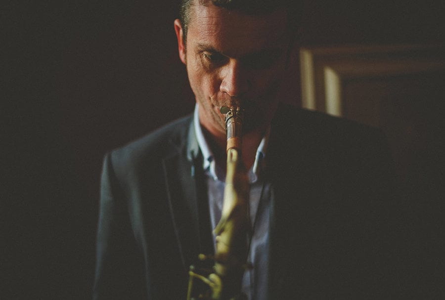 A member of the wedding band plays a saxophone