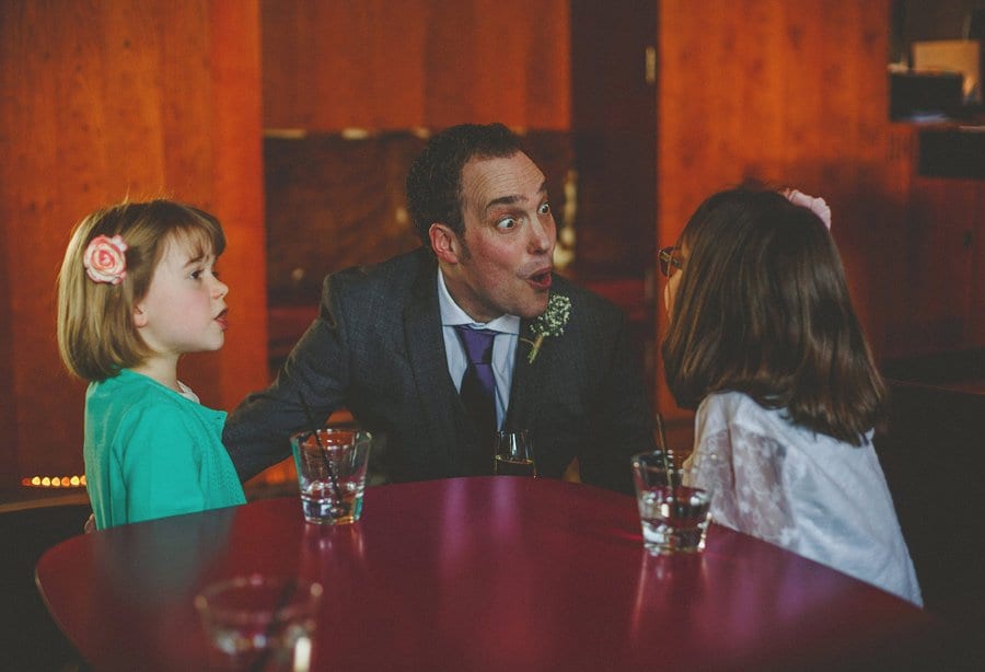 The groom looks startled as he looks at one of the children