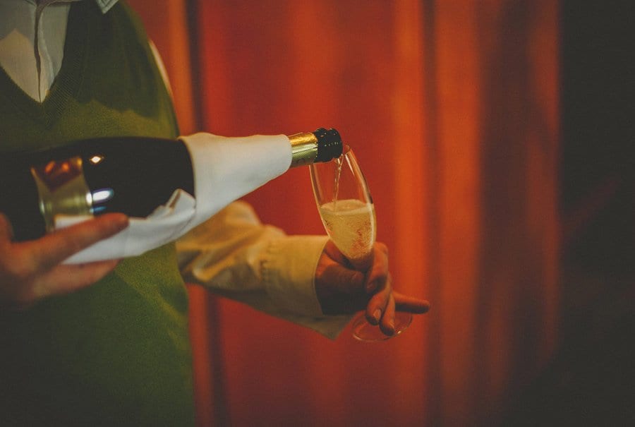 Champagne is poured into a flute by a waiter at Cowley Manor