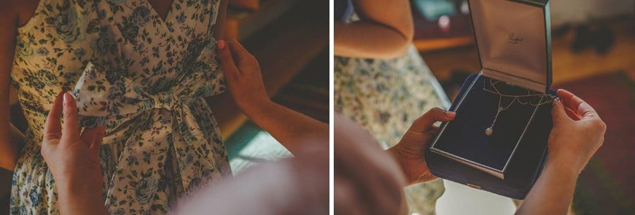 The bride opens up a small box with a gold necklace inside
