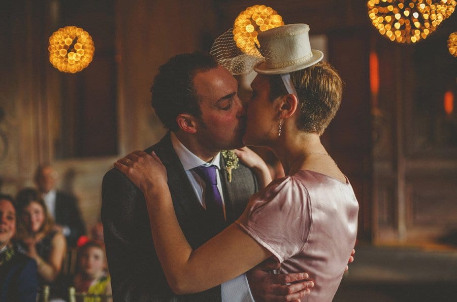 The bride and groom embrace and kiss each other during the wedding ceremony at Cowley Manor