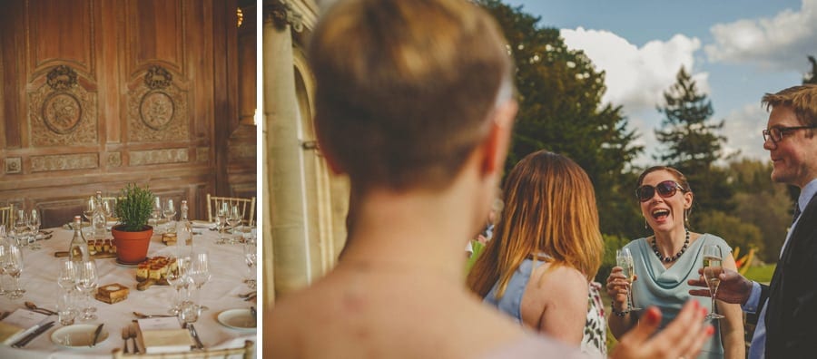 Wedding guests chat amongst themselves in the gardens at Cowley Manor Estate