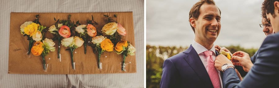 An usher fastens a flower to the grooms suit jacket