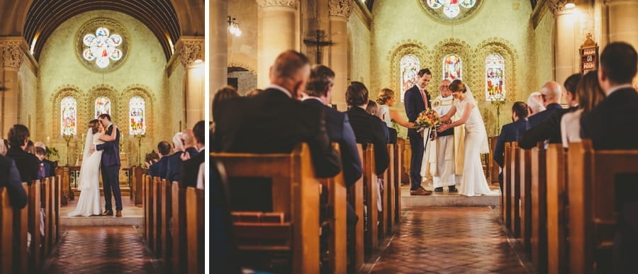 The bride and groom hold each other and kiss in the church during the wedding ceremony