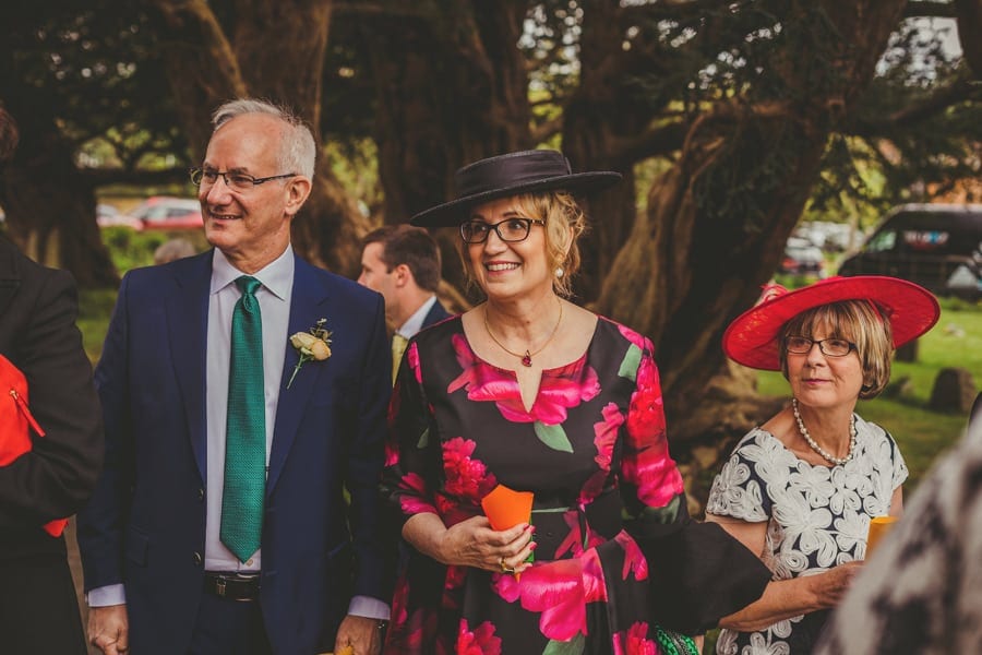 Wedding guests stand outside the Church and wait for the bride and groom