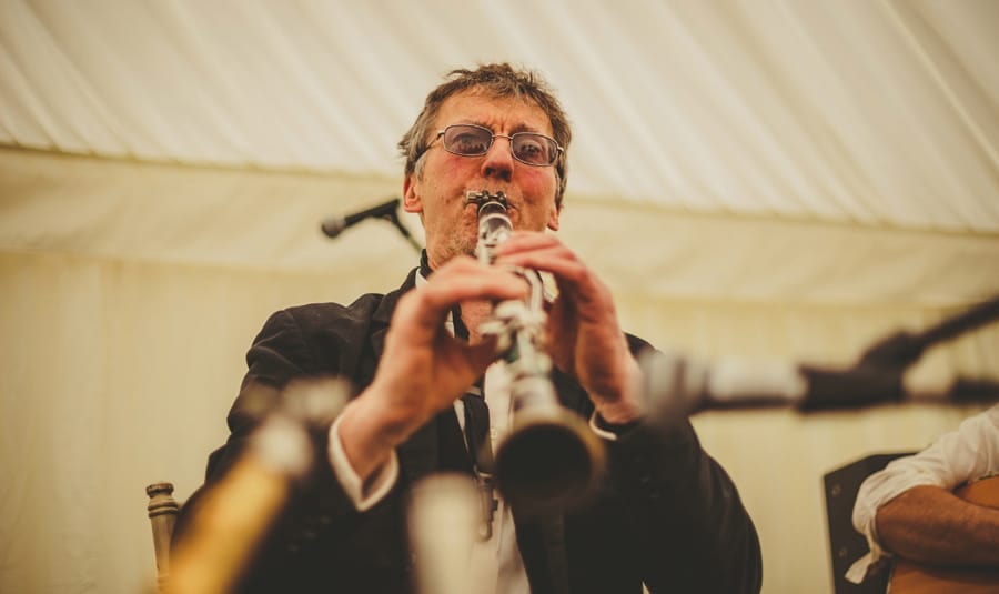A member of the wedding band plays on stage in the marquee