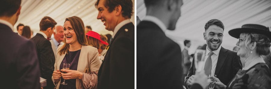 Wedding guests chat to each other in the marquee