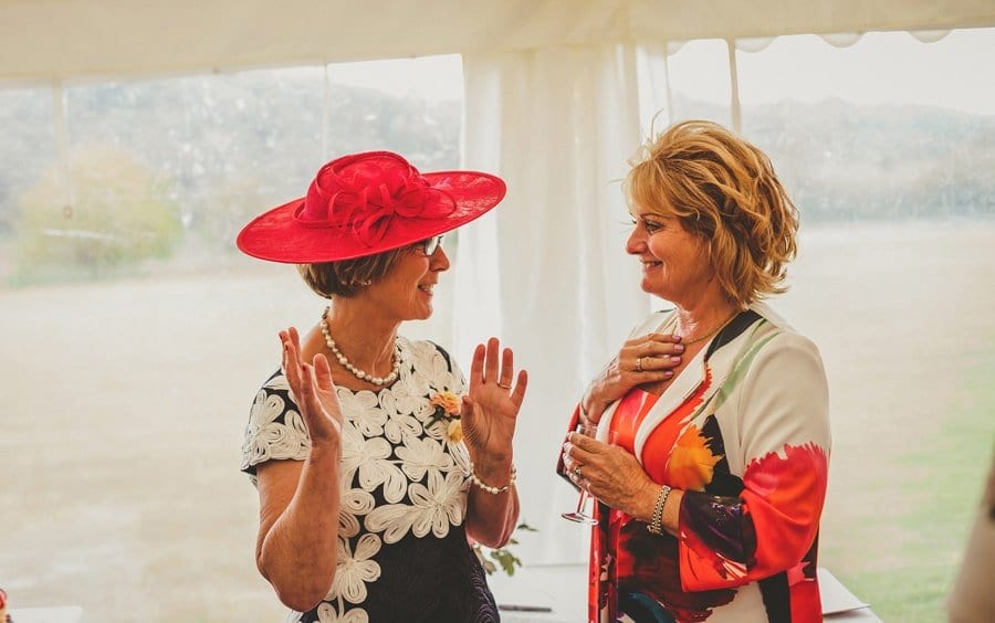 The brides mother talks with a friend in the marquee