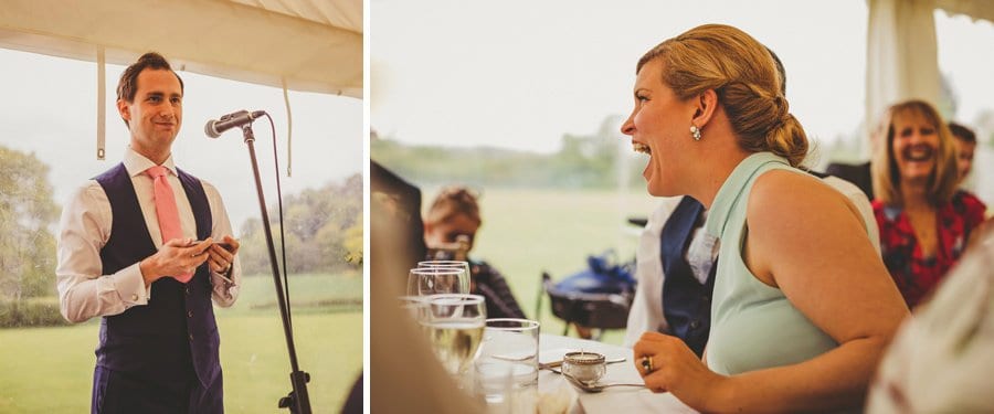 The groom delivers his speech to the wedding party in the marquee