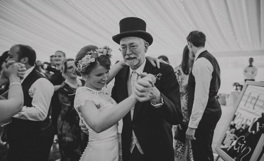 The bride and her father dance together in the marquee