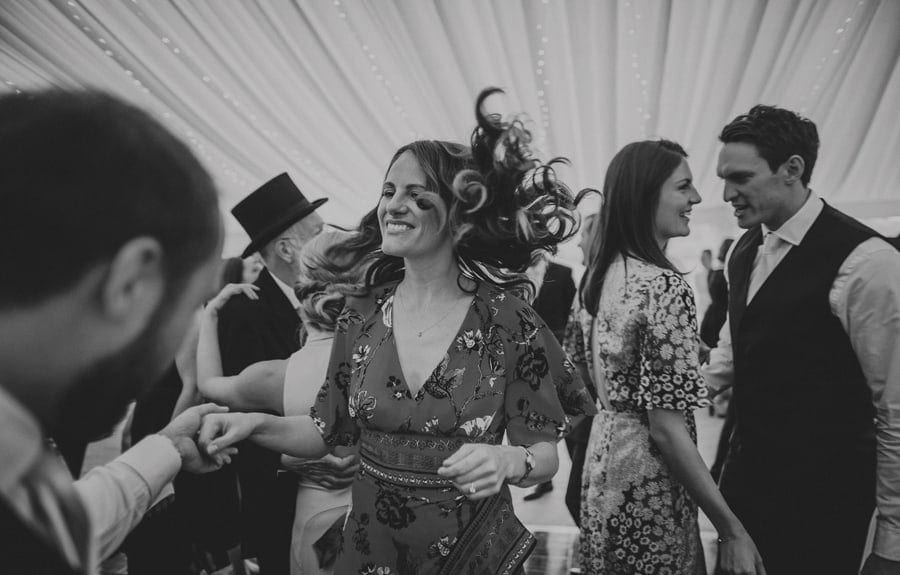 A wedding guest dances with her husband on the dancefloor