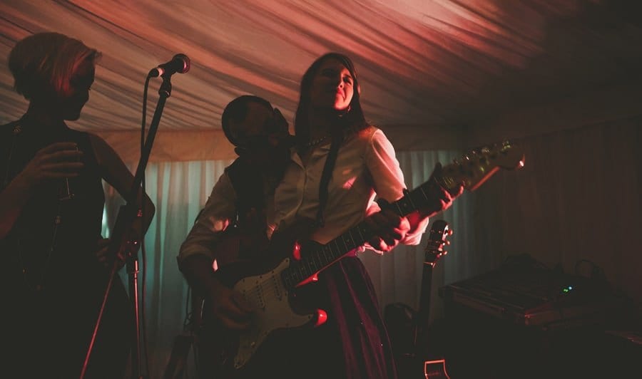 A wedding guest plays guitar on stage