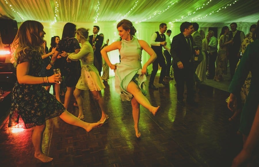 The brides sister lifts up her skirt and kicks her leg out on the dancefloor