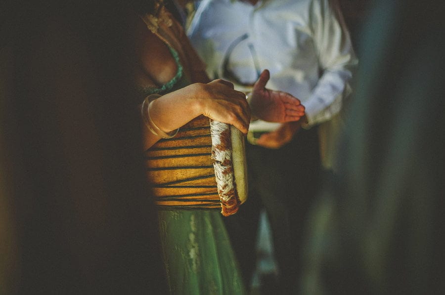 A wedding guest plays the drums in the gardens at Micklefield Hall