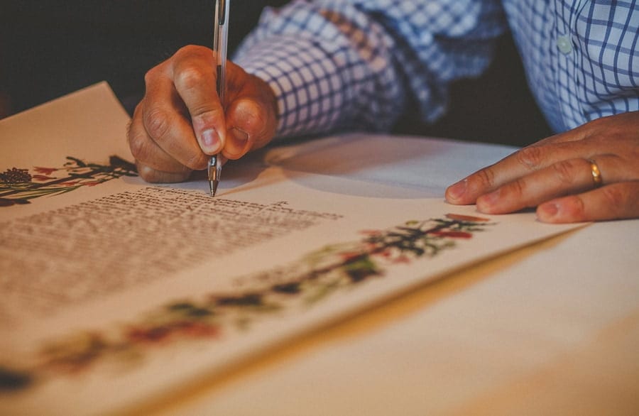 A man signs a contract at Micklefield Hall