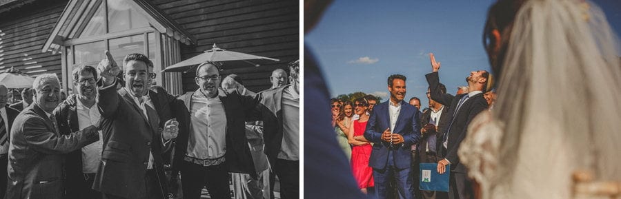 The groom points towards the outdoor ceremony at Micklefield Hall