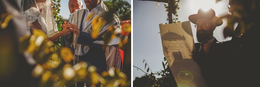 The groom places a wedding ring onto the bride's finger during the outdoor wedding ceremony at Micklefield Hall