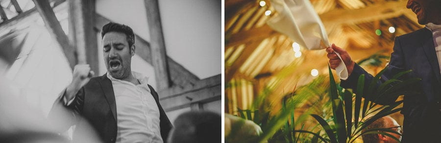 The groom is lifted in the air by friends on the dancefloor