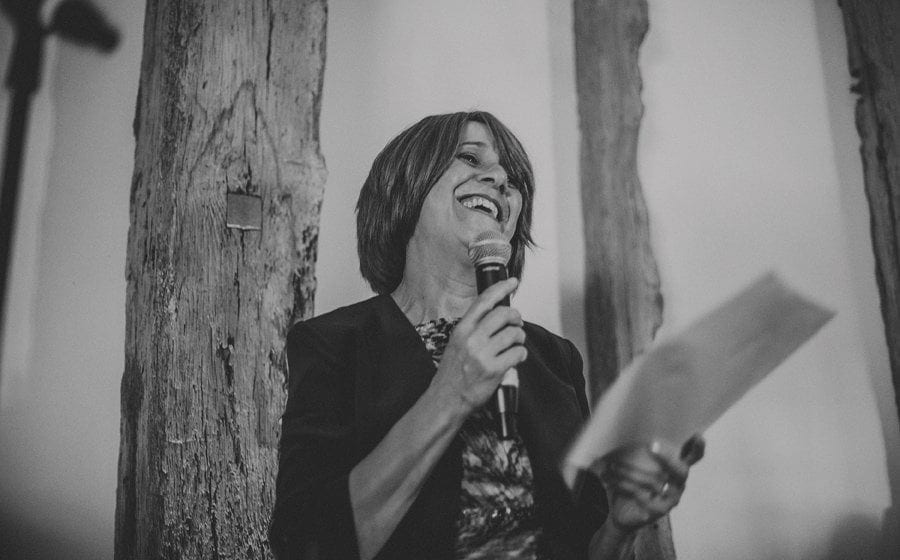 The bride's mother stands up and delivers her speech to the wedding guests