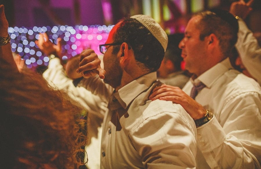 Wedding guests stand close to each other on the dancefloor at Micklefield Hall