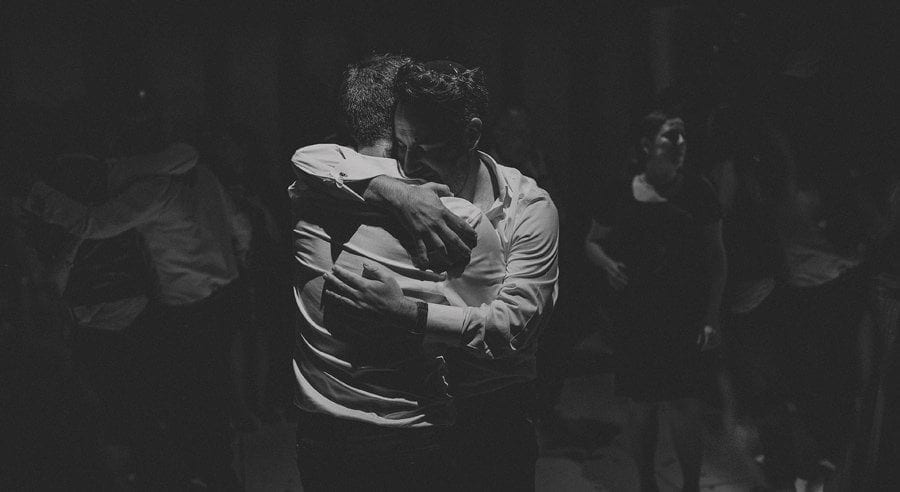 The groom embraces the best man on the dancefloor at Micklefield Hall