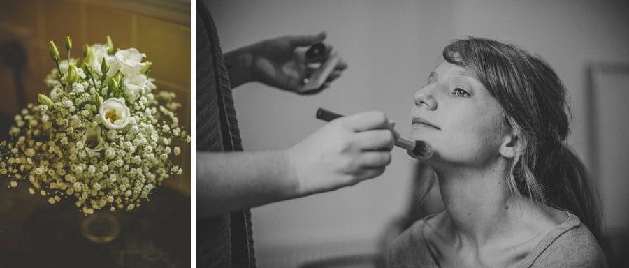 The bride sits in a chair and has her makeup applied by the make up artist