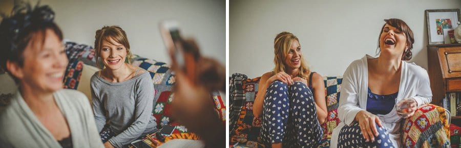 Bridesmaids sat in the front room of the brides house and chat with each other