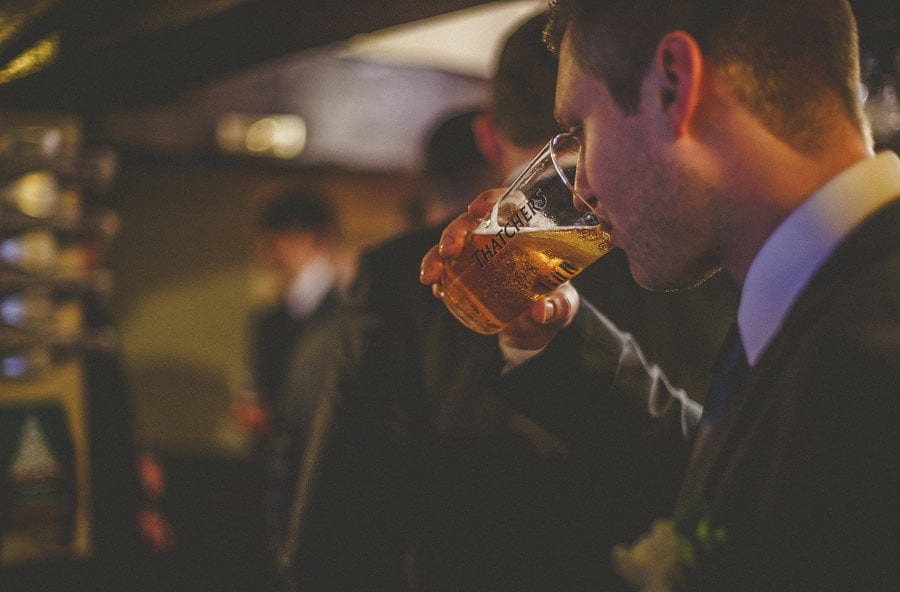 The groom drinks a pint of beer in the public house
