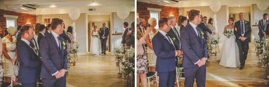 The bride and her father walk down the aisle towards the groom at Sopley Mill