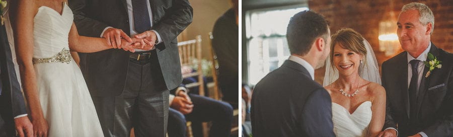 The bride smiles at the groom during the wedding ceremony at Sopley Mill