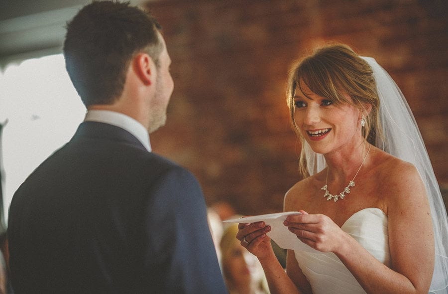 The bride reads a poem to the groom during the wedding ceremony at Sopley Mill