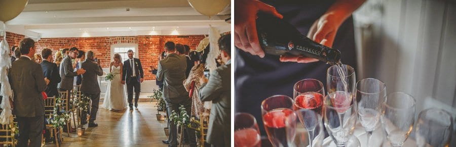 The bride and groom walk down the aisle as guests clap