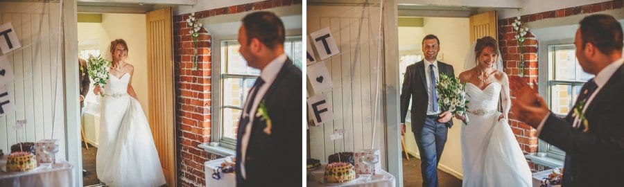 The bride and groom walk into the room