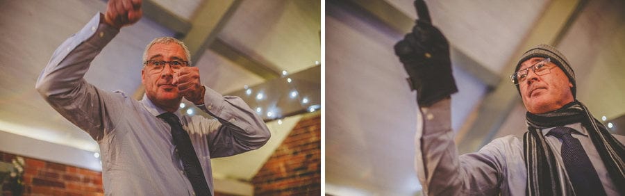The brides father wears a large glove and hat for his wedding speech