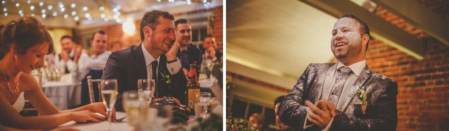 The bride and groom laugh during the best man's wedding speech