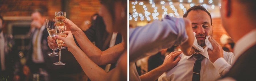 Wedding guest use tissues to take talcum powder off the best mans face