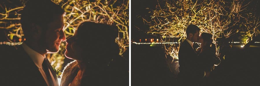 The bride and groom kiss each other outside Sopley Mill