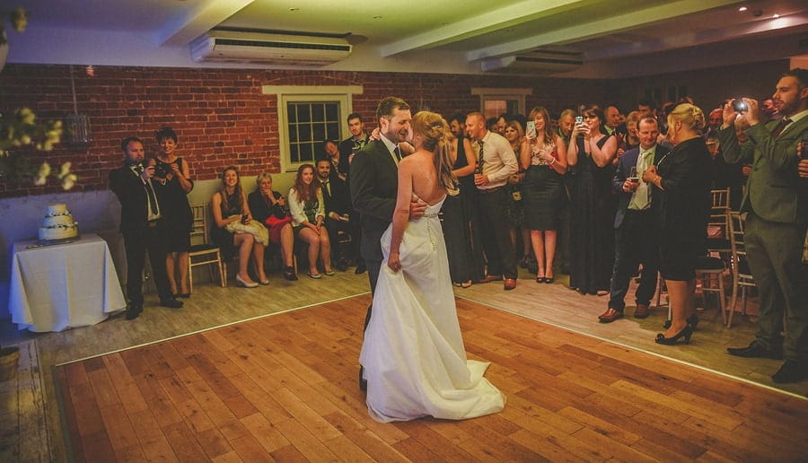 The bride and groom dance in front of wedding guests at Sopley Mill