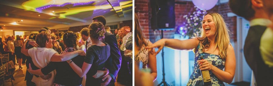 Wedding guests embrace each other on the dancefloor at Sopley Mill