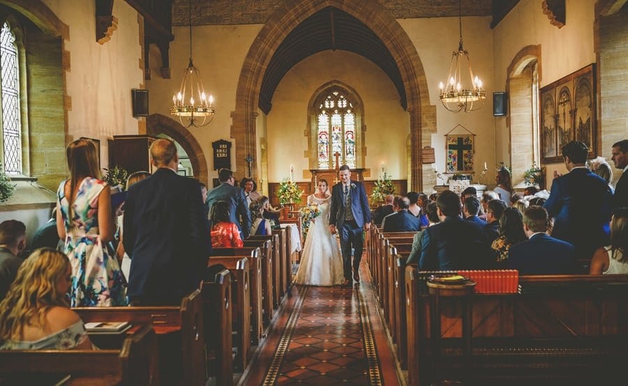 The bride and groom walk down the aisle together at the end of the wedding ceremony