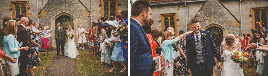 The bride and groom leave the church as wedding guests throw confetti in the air