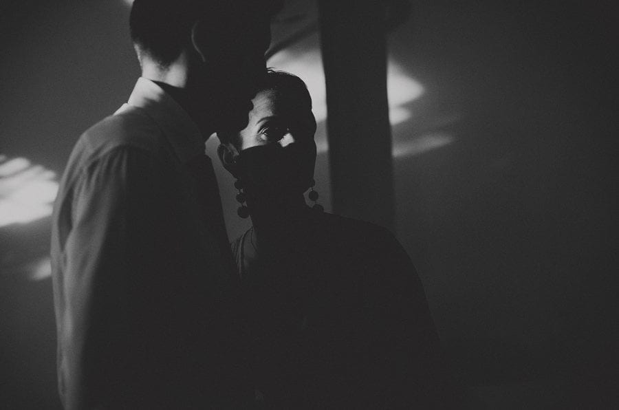 The bride listens to a friend as they chat with each other on the dancefloor
