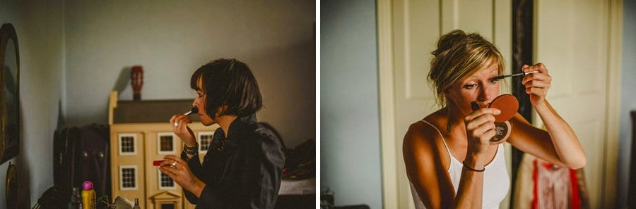 A bridesmaid looks into her hand held mirror and applies mascara to her eye lashes