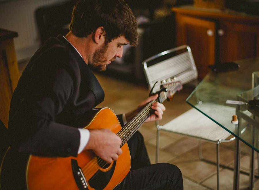 A man plays his guitar