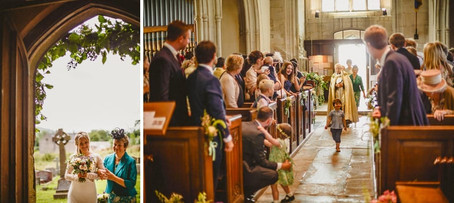 The vicar walks the bridal party down the aisle of the church