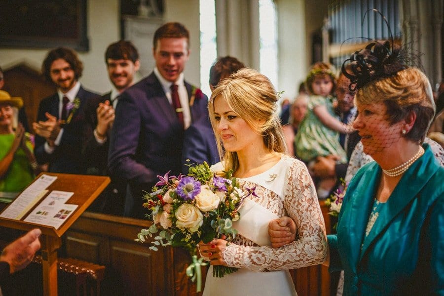 The bride and her mother walk to the end of the aisle together