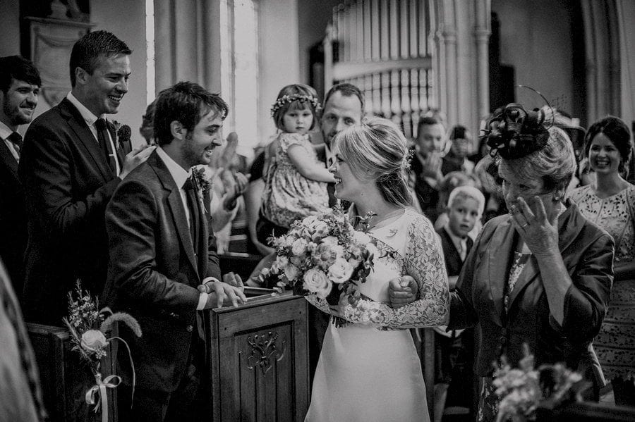 The bride arrives and smiles at the groom