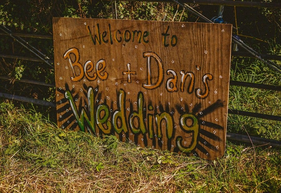 A wooden poster board on the grass